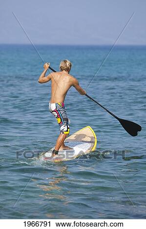 Stock Image - Hawaii, Maui, Makena, Athletic Stand Up Paddle Surfer In Ocean. Fotosearch