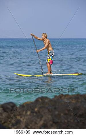 Hawaii, Maui, Makena, Athletic Stand Up Paddle Surfer In Ocean View Large Photo Image Stock Photo - Hawaii, Maui, Makena, Athletic Stand Up Paddle Surfer In Ocean. Fotosearch