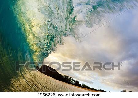 Stock Photograph - Hawaii, Maui, Makena Beach, Beautiful Wave Breaking Along Shore, Sunset Light.. Fotosearch