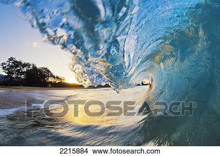 Hawaii, Maui, Makena, Beautiful blue ocean wave breaking at the beach at sunrise View Large Photo Image Picture - Hawaii, Maui, Makena, Beautiful blue ocean wave breaking at the beach at sunrise. Fotosearch