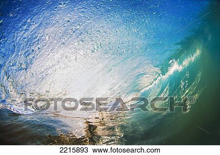 Stock Image - Hawaii, Maui, Makena, Beautiful blue wave breaking at the beach.. Fotosearch