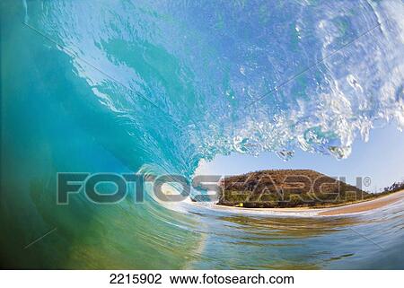 Stock Image - Hawaii, Maui, Makena, Beautiful blue wave breaking at the beach.. Fotosearch