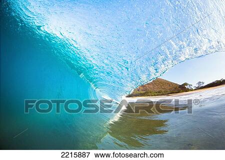 Stock Photo - Hawaii, Maui, Makena, Beautiful blue wave breaking at the beach.. Fotosearch