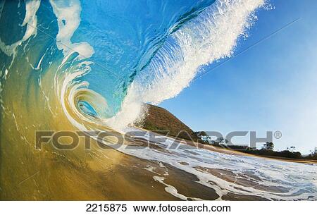 Stock Photography - Hawaii, Maui, Makena, Beautiful blue ocean wave breaking at the beach.. Fotosearch