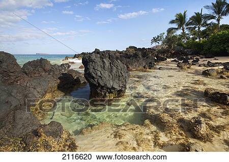 Stock Image - Hawaii, Maui, Makena, Beautiful clear ocean among lava rock.. Fotosearch