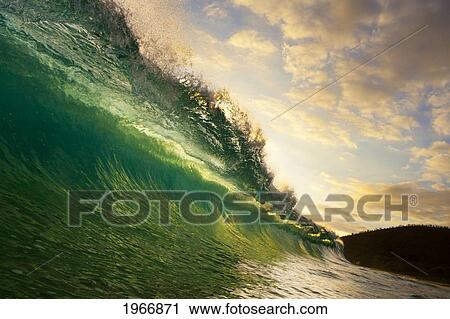 Stock Image - Hawaii, Maui, Makena, Beautiful Wave At Sunset, View From Inside The Barrel. Fotosearch