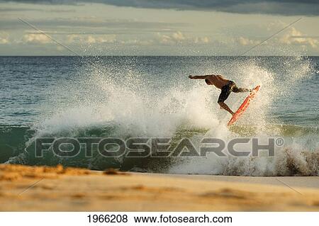 Stock Photo - Hawaii, Maui, Makena - Big Beach, Man Skimboarding Shoreline Surf.. Fotosearch