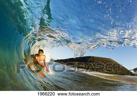 Stock Image - Hawaii, Maui, Makena - Big Beach, Boogie Boarder Riding Barrel Of Beautiful Wave, Sunrise Light.. Fotosearch