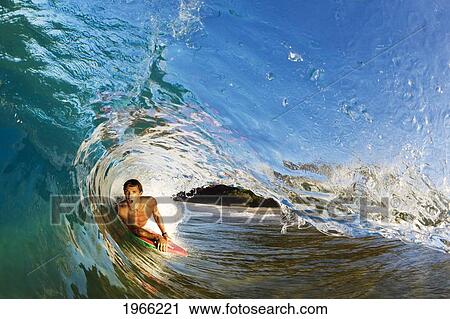 Hawaii, Maui, Makena - Big Beach, Boogie Boarder Riding Barrel Of Beautiful Wave, Sunrise Light. View Large Photo Image Stock Image - Hawaii, Maui, Makena - Big Beach, Boogie Boarder Riding Barrel Of Beautiful Wave, Sunrise Light.. Fotosearch