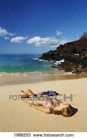Stock Image - Hawaii, Maui, Makena - Big Beach, Beautiful Woman With Snorkel Gear Relaxing On Sandy Shore.. Fotosearch
