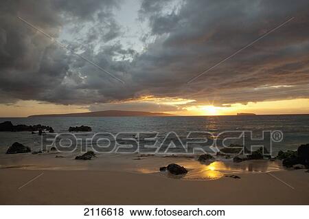 Stock Photo - Hawaii, Maui, Makena, Cloudy sunset at Big Beach.. Fotosearch