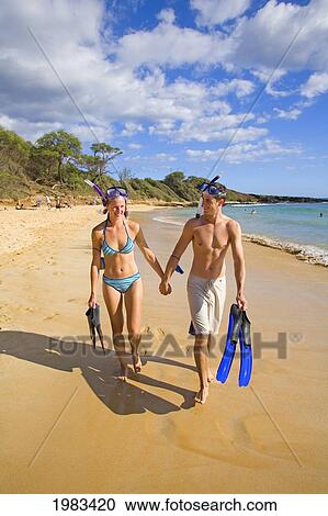 Hawaii, Maui, Makena, Couple Walking On Little Beach After Snorkeling. View Large Photo Image Stock Image - Hawaii, Maui, Makena, Couple Walking On Little Beach After Snorkeling.. Fotosearch