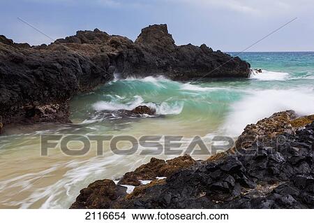Picture - Hawaii, Maui, Makena, Ocean wave on rocky coastline.. Fotosearch