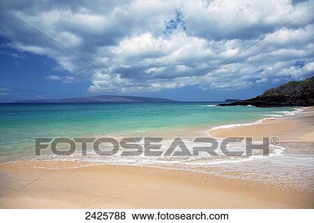 Stock Photo - Hawaii, Maui, Makena, Sandy Makena Beach with land in the distance.. Fotosearch