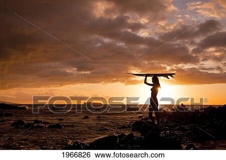 Stock Photograph - Hawaii, Maui, Makena, Silhouette Of Surfer Girl At Sunset. Fotosearch