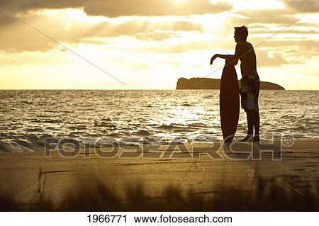 Stock Image - Hawaii, Maui, Makena, Skimboarder Silhouette At Sunset. Fotosearch