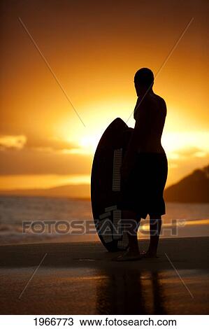 Stock Image - Hawaii, Maui, Makena, Skimboarder Silhouette At Sunset. Fotosearch