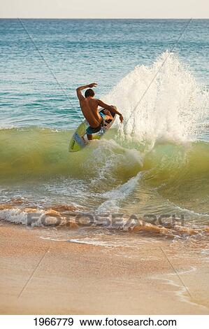 Stock Photo - Hawaii, Maui, Makena, Skimboarder Carves Big Turn On Wave. Fotosearch