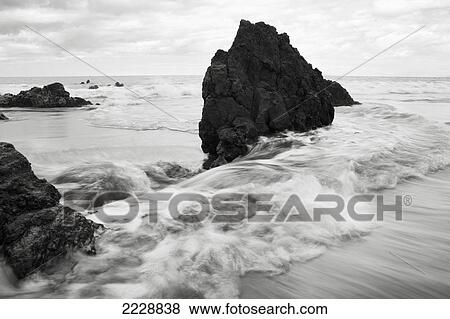 Stock Photo - Hawaii, Maui, Makena, Soft Water Crashes On Lava Rocks On The Beach. Fotosearch
