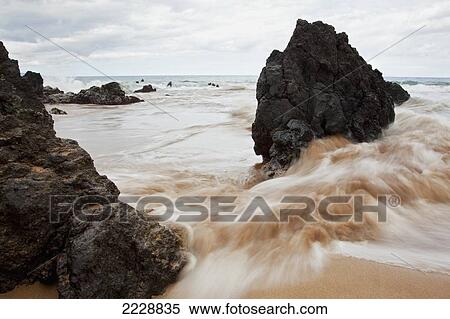 Hawaii, Maui, Makena, Soft Water Crashes On Lava Rocks On The Beach View Large Photo Image Stock Photography - Hawaii, Maui, Makena, Soft Water Crashes On Lava Rocks On The Beach. Fotosearch