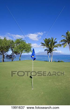 Stock Photo - Hawaii, Maui, Makena South Golf Course, Hole #16, Putting Green Next To The Ocean.. Fotosearch