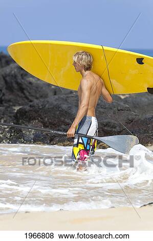 Stock Photo - Hawaii, Maui, Makena, Stand Up Paddle Surfer With Board On Beach. Fotosearch