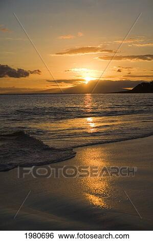Stock Photograph - Hawaii, Maui, Makena State Park, Oneloa Or Big Beach, Water Lapping Onto Shore At Sunset.. Fotosearch