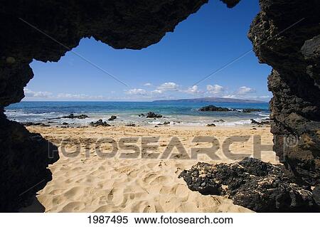 Hawaii, Maui, Makena, View From Secret Beach Of Kahoolawe From Inside Of A Lavatube Cavern. View Large Photo Image Stock Photography - Hawaii, Maui, Makena, View From Secret Beach Of Kahoolawe From Inside Of A Lavatube Cavern.. Fotosearch