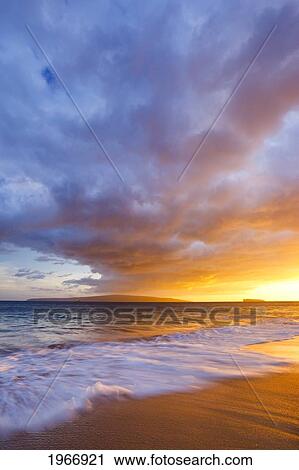 Stock Image - Hawaii, Maui, Makena, Wave Washes Over Sand At Makena Beach At Susnet. Fotosearch