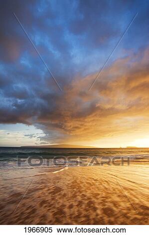 Stock Photography - Hawaii, Maui, Makena, Wave Washes Over Sand At Makena Beach At Sunset. Fotosearch