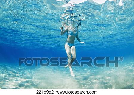 Hawaii, Maui, Makena, Young woman swimming near ocean surface, View from below. View Large Photo Image Stock Image - Hawaii, Maui, Makena, Young woman swimming near ocean surface, View from below.. Fotosearch