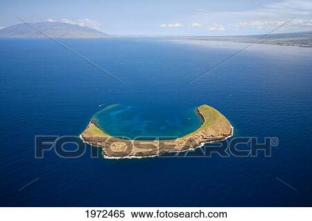 Stock Photography - Hawaii, Maui, Molokini, Aerial Shot Of The Crescent Shaped Islet From Behind, Maui In Distance.. Fotosearch
