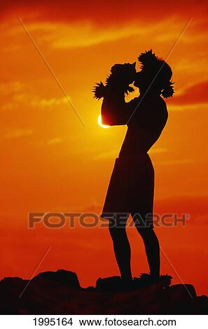 Hawaii, Maui, Napili, Silhouette Of Man Blowing Conch Shell At Sunset, Fiery Orange Sky. View Large Photo Image Picture - Hawaii, Maui, Napili, Silhouette Of Man Blowing Conch Shell At Sunset, Fiery Orange Sky.. Fotosearch
