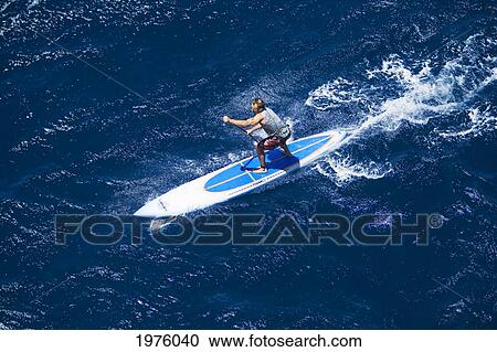 Stock Image - Hawaii, Maui, North Shore, Mark Raaphorst Stand Up Paddling.. Fotosearch