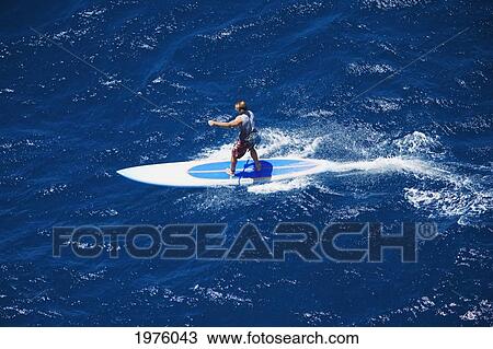 Stock Image - Hawaii, Maui, North Shore, Mark Raaphorst Stand Up Paddling.. Fotosearch