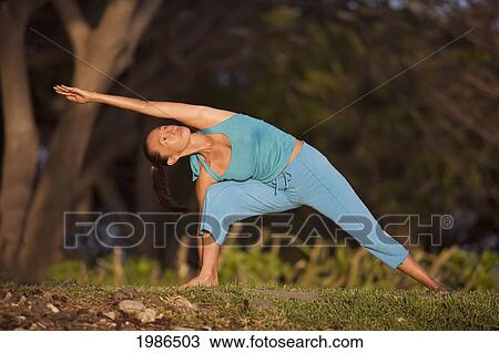 Hawaii, Maui, Olowalu, Woman Doing Yoga In Grass. View Large Photo Image Stock Image - Hawaii, Maui, Olowalu, Woman Doing Yoga In Grass.. Fotosearch