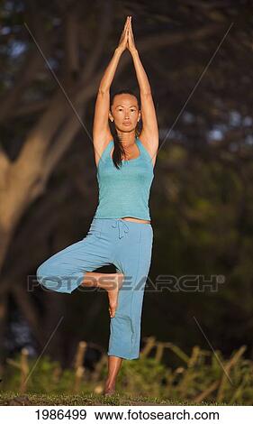 Hawaii, Maui, Olowalu, Woman Doing Yoga In Grass. View Large Photo Image Stock Photo - Hawaii, Maui, Olowalu, Woman Doing Yoga In Grass.. Fotosearch