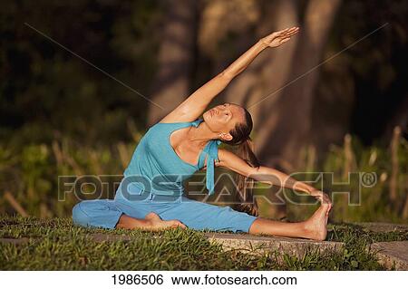 Stock Photograph - Hawaii, Maui, Olowalu, Woman Doing Yoga In Grass.. Fotosearch