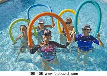 Hawaii, Maui, Paia, Maui Country Club, Aquasize Class, Smiling Women Holding Colorful Devices. View Large Photo Image Stock Photo - Hawaii, Maui, Paia, Maui Country Club, Aquasize Class, Smiling Women Holding Colorful Devices.. Fotosearch
