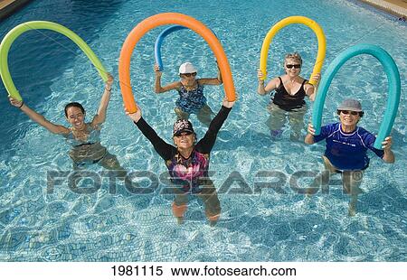 Stock Photography - Hawaii, Maui, Paia, Maui Country Club, Aquasize Class, Five Women Holding Floating Devices In Air.. Fotosearch