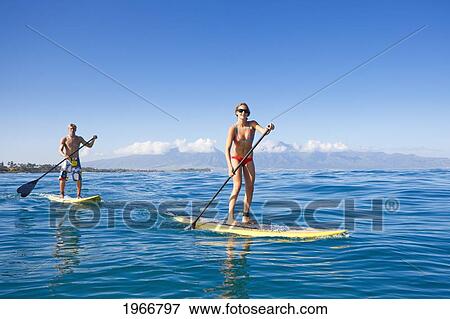 Stock Photo - Hawaii, Maui, Paia, Paddle Boarders In The Ocean Off Maui's North Shore /Nno Commercial Use. Fotosearch