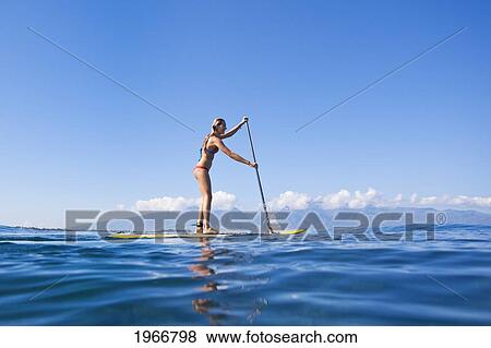 Hawaii, Maui, Paia, Young Woman Stand Up Paddling Shore/N/Nno Commercial Use View Large Photo Image Stock Photo - Hawaii, Maui, Paia, Young Woman Stand Up Paddling Shore/N/Nno Commercial Use. Fotosearch