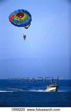 Stock Image - Hawaii, Maui, Parasailing In Molokai Channel. Fotosearch
