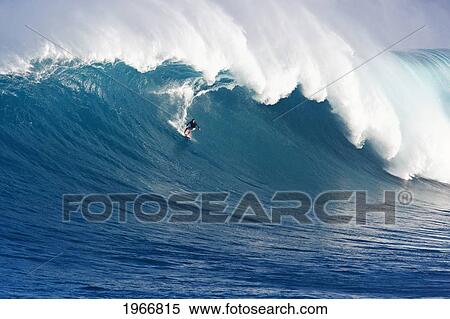 Stock Photography - Hawaii, Maui, Peahi (Jaws), Surfer Rides A Giant Wave. Fotosearch