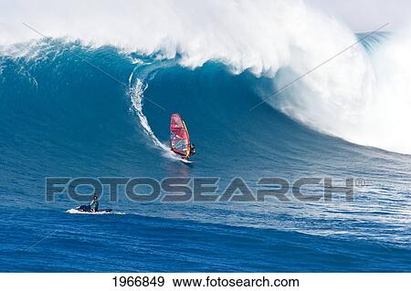 Stock Photo - Hawaii, Maui, Peahi (Jaws), Windsurfer Rides Large Wave And Jetskier In Foreground. Fotosearch