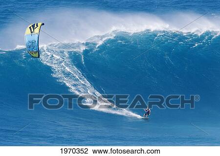Hawaii, Maui, Peahi, Kitebaorder Rides A Large Wave At Peahi, Also Know As Jaws. For Editorial Use Only. View Large Photo Image Stock Image - Hawaii, Maui, Peahi, Kitebaorder Rides A Large Wave At Peahi, Also Know As Jaws. For Editorial Use Only.. Fotosearch