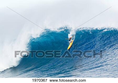 Stock Photo - Hawaii, Maui, Peahi, Professional Surfer Danilo Couto Rides A Wave At Peahi, Also Know As Jaws. For Editorial Use Only.. Fotosearch