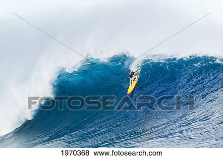 Stock Photo - Hawaii, Maui, Peahi, Professional Surfer Danilo Couto Rides A Wave At Peahi, Also Know As Jaws. For Editorial Use Only.. Fotosearch