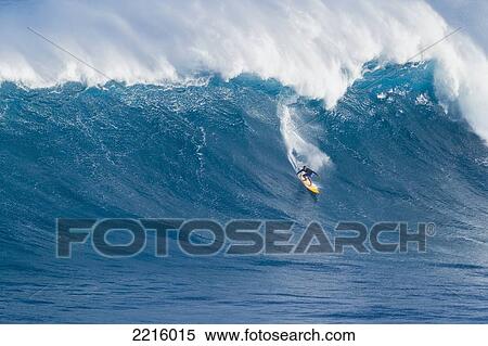 Stock Photography - Hawaii, Maui, Peahi, Professional Surfer Robbie Naish Stand Up Paddling Giant Wave at Jaws.. Fotosearch