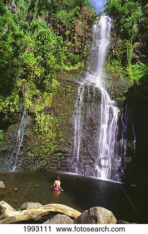 Stock Image - Hawaii, Maui, Pi'lani Highway, Woman Swimming At Wailua Falls.. Fotosearch